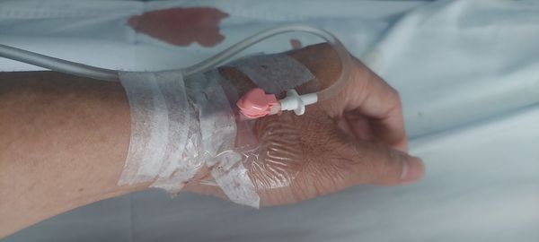 High angle view of woman hand on bed