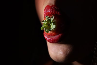 Close-up of strawberry over black background