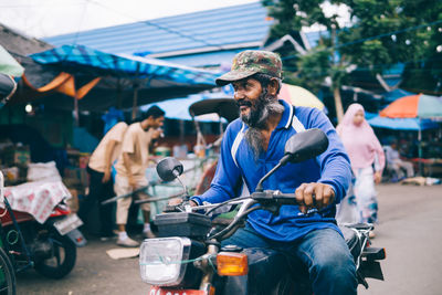 People sitting at market stall