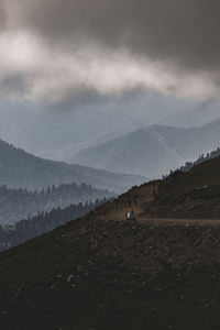 Scenic view of mountains against cloudy sky