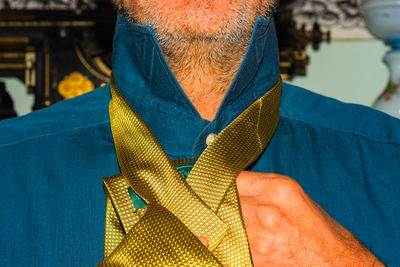 Close-up of man wearing mask against blue background