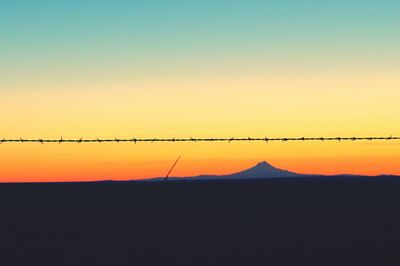 Silhouette of mountain against sky at sunset