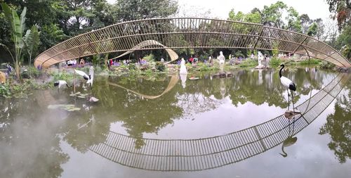 People on footbridge over lake