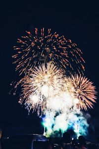 Low angle view of firework display against sky at night