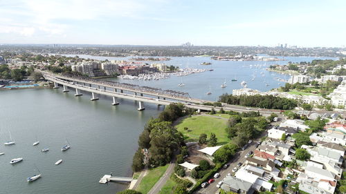 High angle view of bridge over river in city against sky