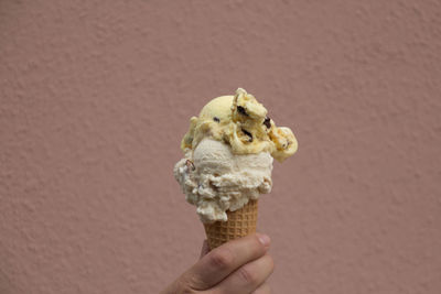 Human hand holding ice cream cone