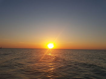 Scenic view of sea against clear sky during sunset