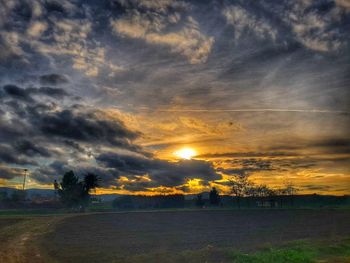 Scenic view of field against dramatic sky