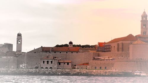 Buildings in city at sunset