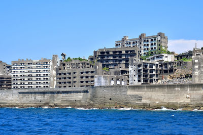 Buildings in city against blue sky