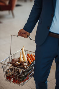 Mature businessman with basket of vegetables