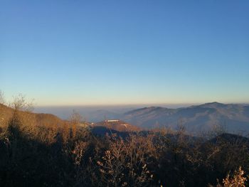 Scenic view of mountains against clear sky during winter