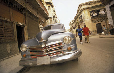 Vintage car on street by old building