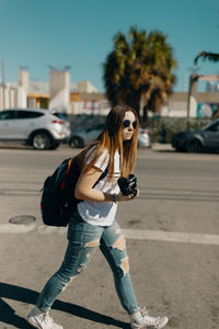 Full length of young woman on road in city