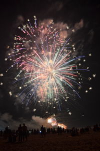 Low angle view of firework display at night