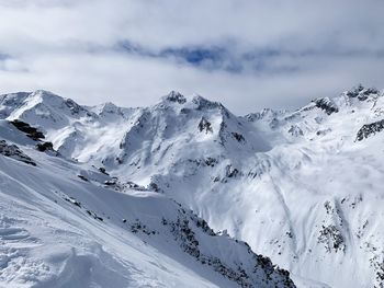 Scenic view of snow covered mountains against sky