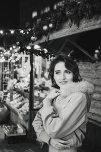 Portrait of smiling young woman standing outdoors