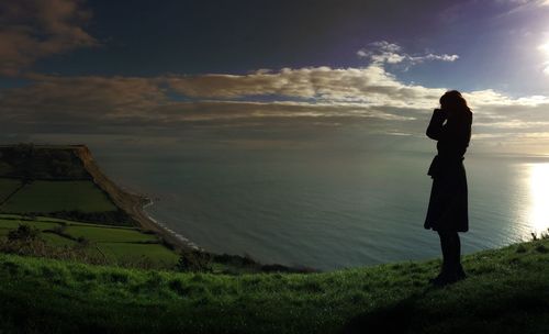 Rear view of man standing on beach