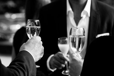 Close-up of hand holding beer glass