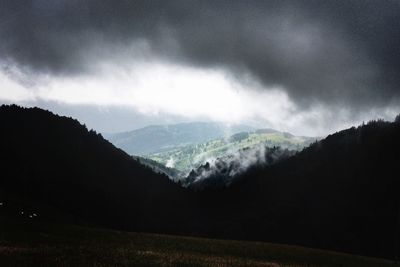 Scenic view of mountains against cloudy sky