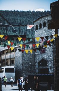 Colorful bunting hanging against buildings in city