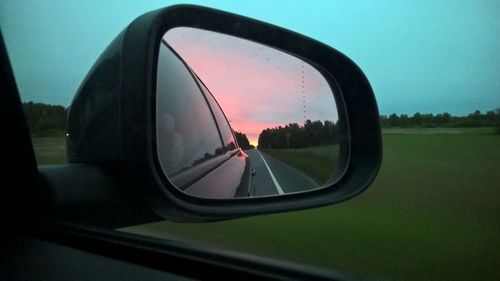 Reflection of car on side-view mirror