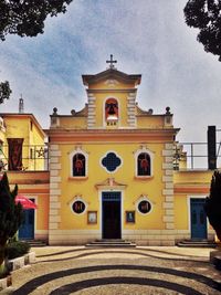 Exterior of church in city against sky