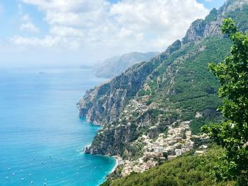 High angle view of sea and mountains against sky