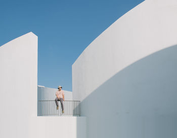 Low angle view of person on staircase against sky