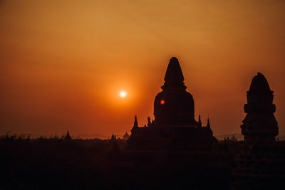 Silhouette temple against sky during sunset