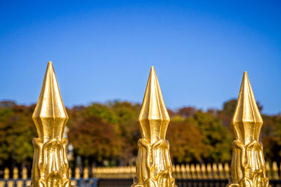 Close-up of temple against building against clear blue sky