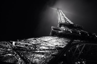 Low angle view of illuminated building against sky at night