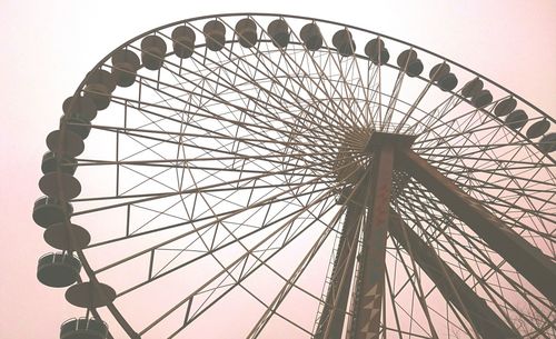 Low angle view of ferris wheel against sky