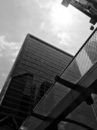 Low angle view of skyscrapers against cloudy sky