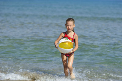 Girl playing at sea