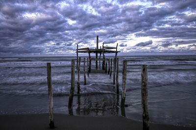 Lifeguard hut on beach against sky