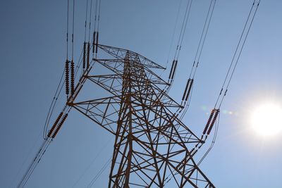 Low angle view of electricity pylon against sky