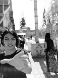 Close-up portrait of a woman reaching towards camera