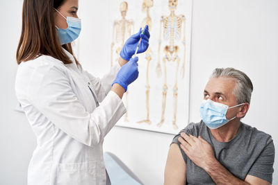 Female doctor examining patient in clinic