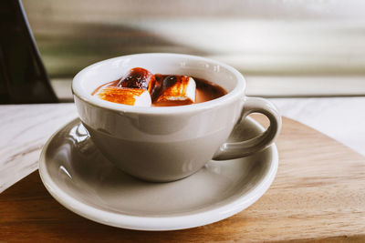 Hot chocolate with marshmallows in pastel mug.