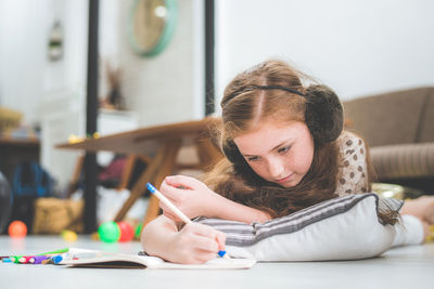 Girl writing on book