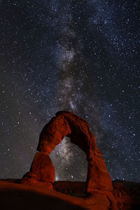 Rock formation against sky at night