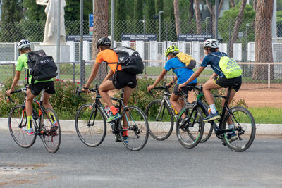 People riding bicycle on road