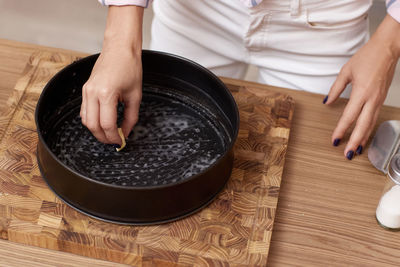 Midsection of woman preparing food on table