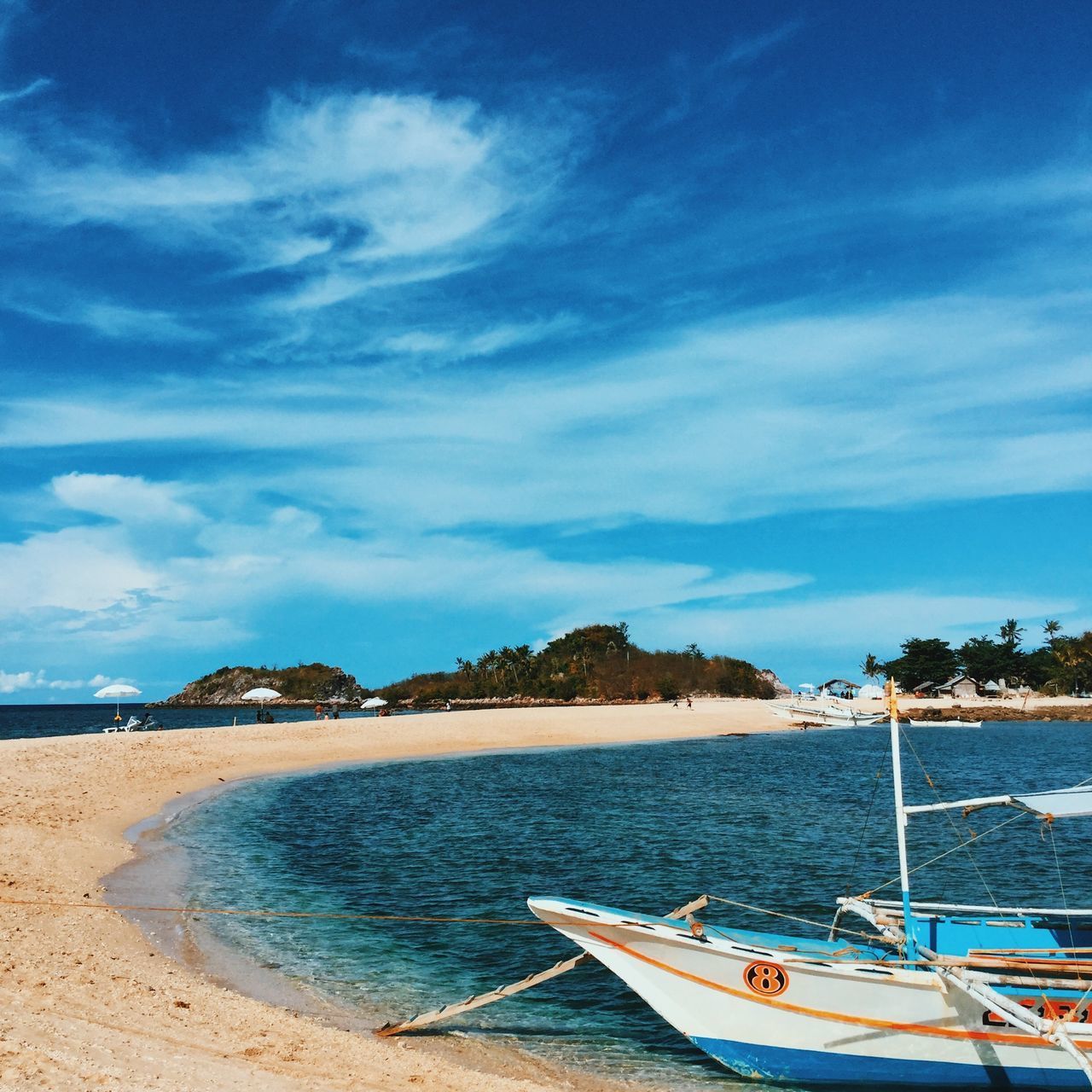 SCENIC VIEW OF BEACH AGAINST BLUE SKY