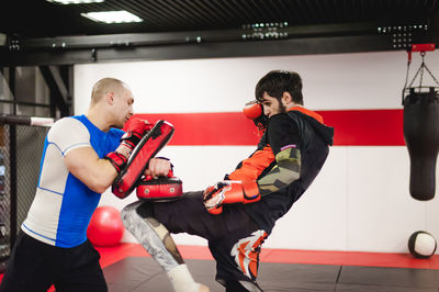 People practicing boxing in ring