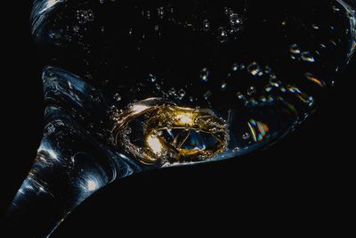 Close-up of glass sculpture against black background