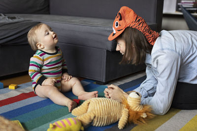 Mother playing with baby at home