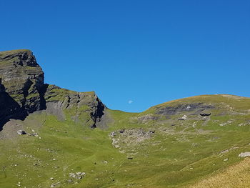 Scenic view of mountains against clear blue sky