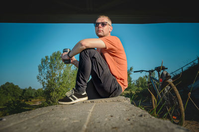 Portrait of young man standing on road